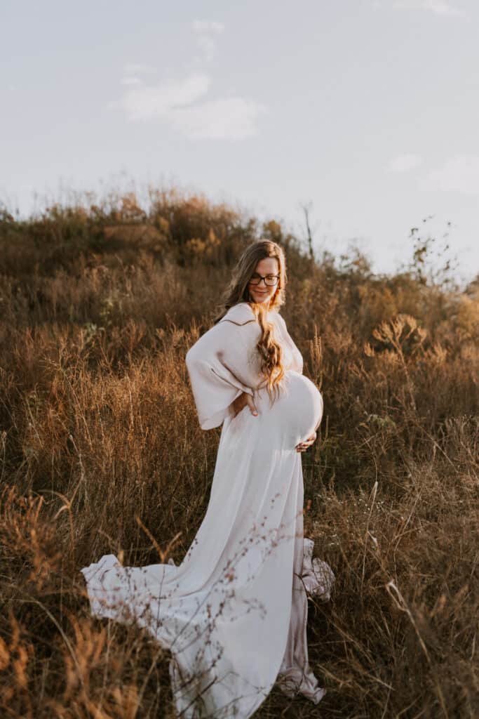 pregnant mother wearing a flowy dress taking maternity photos