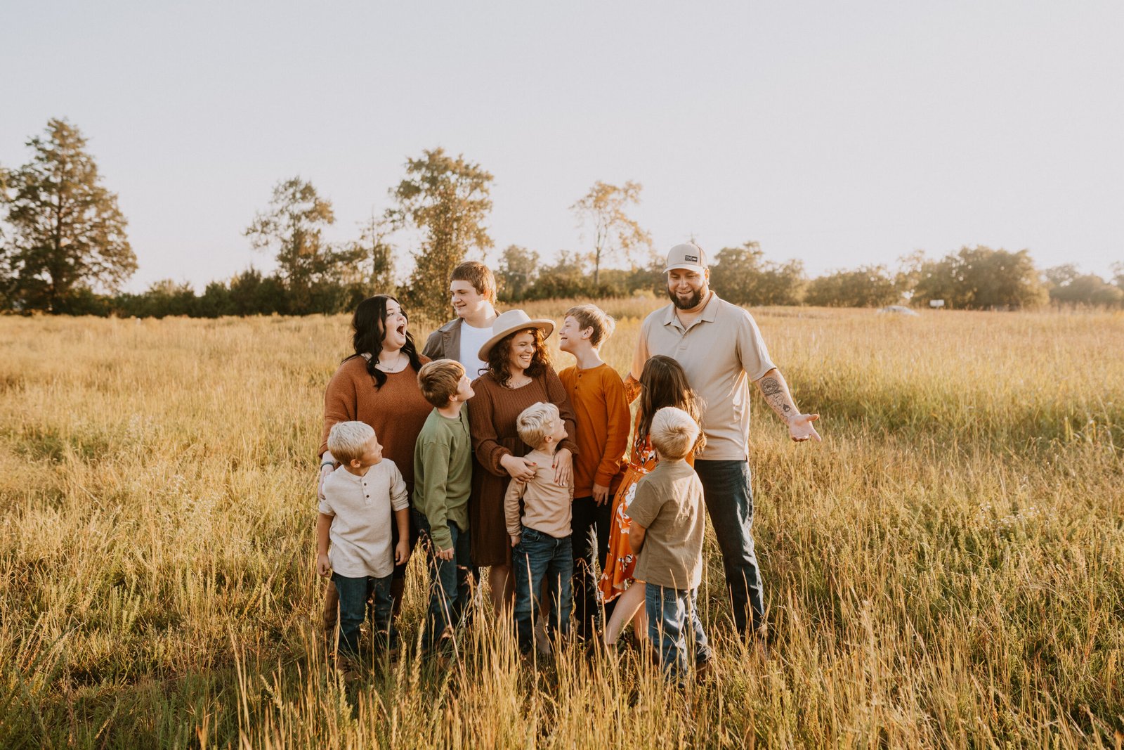 Blended family together in an open field