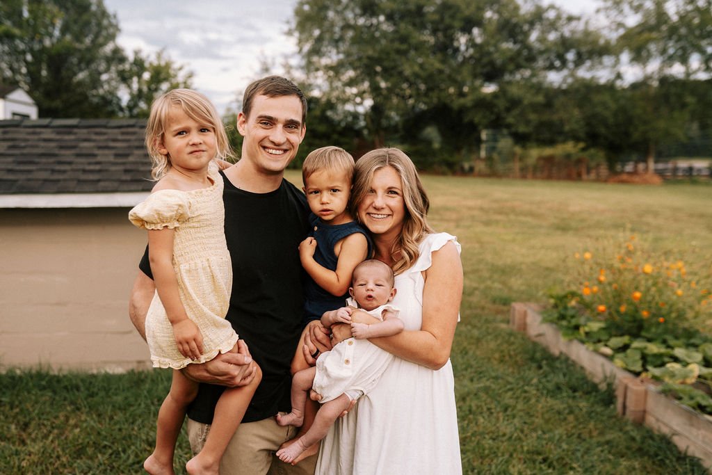 Family of five relaxing together during newborn session