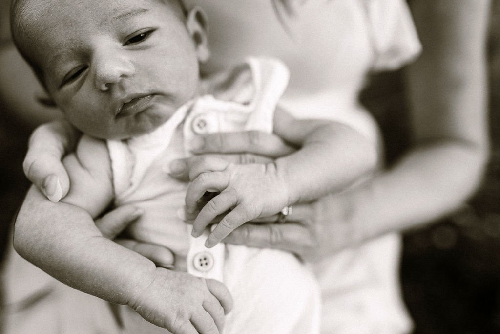 Black and white image of mom holding newborn